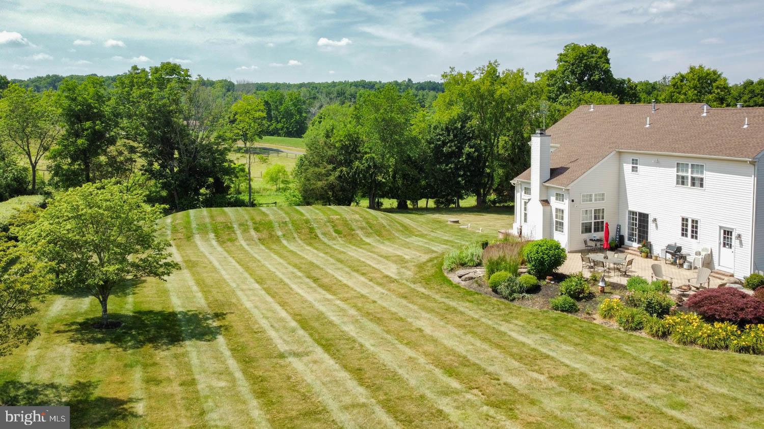 1026 Creamery Road Perkasie, PA 18944 - Photo 42 of 45 a view of a backyard with plants and large trees
