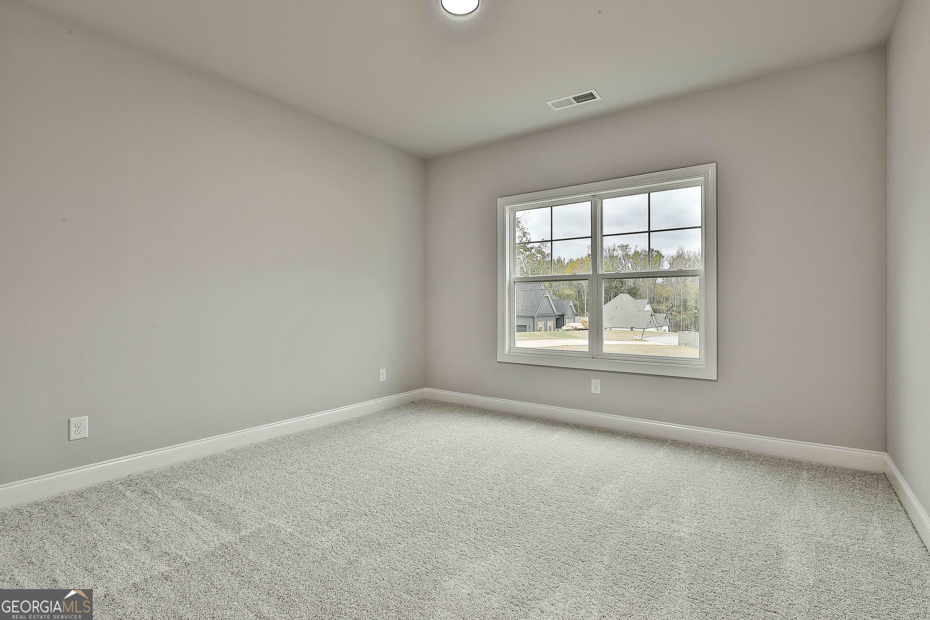 152 Wet Wood Drive, Unit 10 Fairburn, GA 30213 - Photo 12 of 39 an empty room with windows