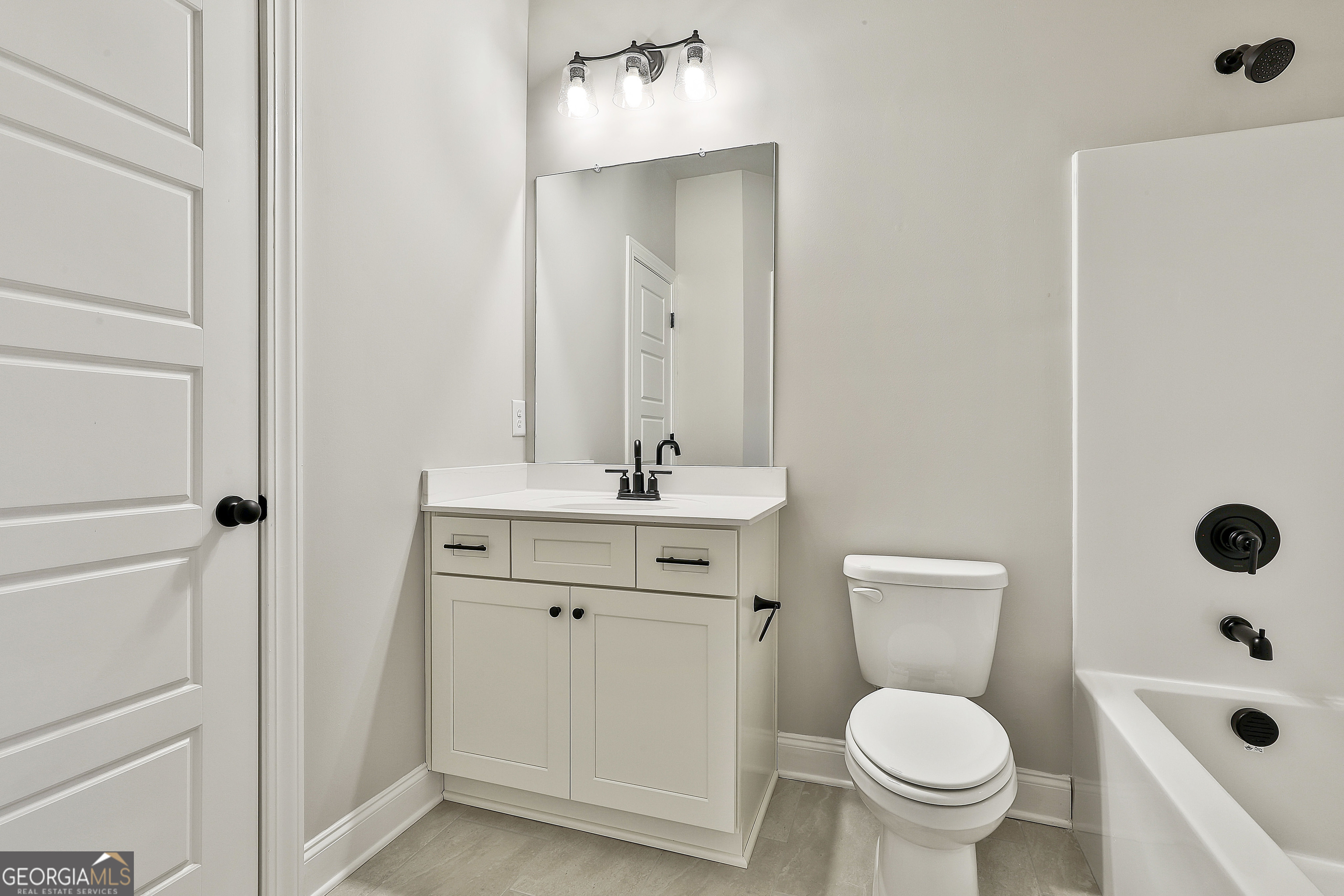 152 Wet Wood Drive, Unit 10 Fairburn, GA 30213 - Photo 13 of 39 a bathroom with a sink toilet and shower