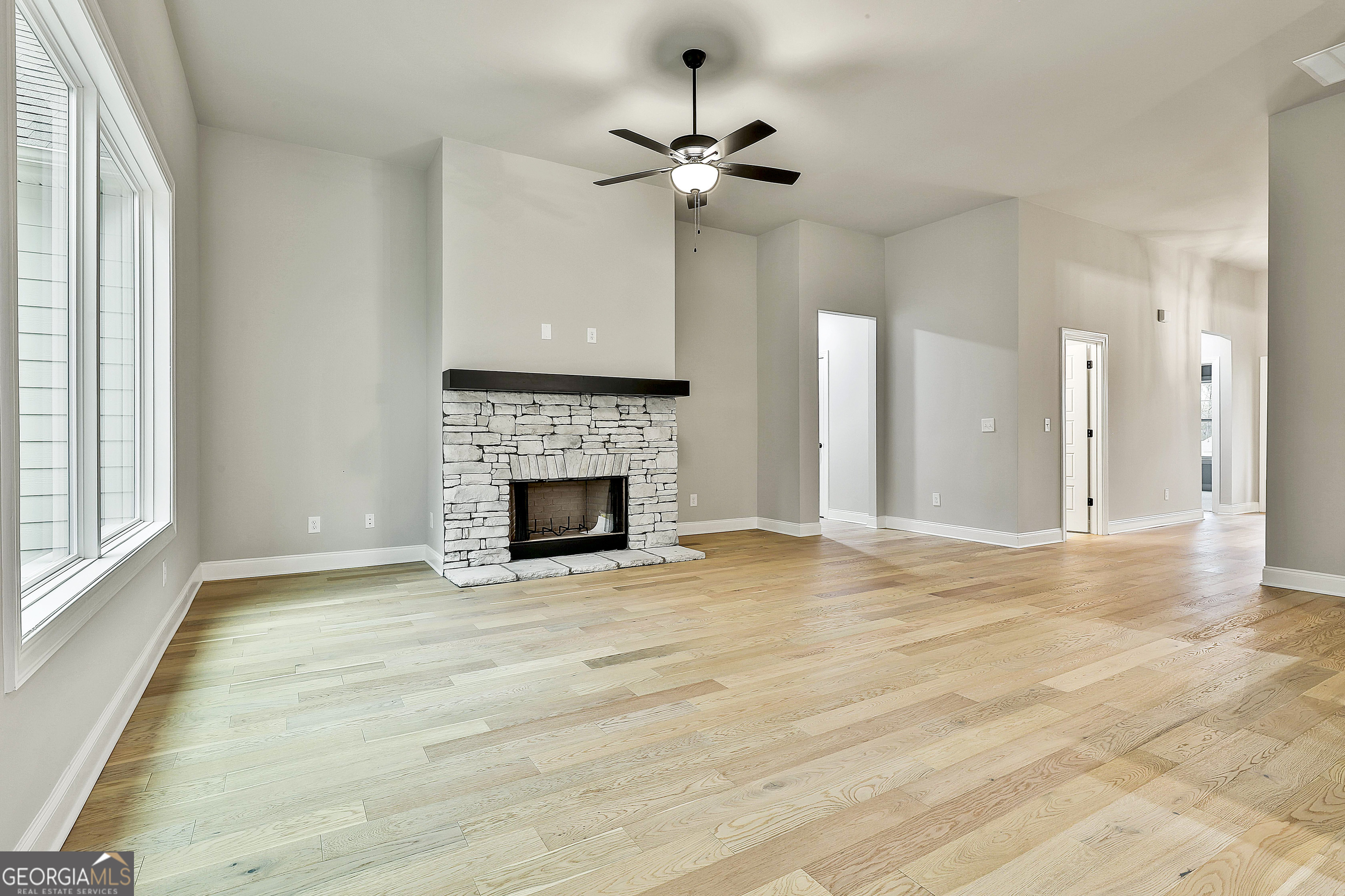 152 Wet Wood Drive, Unit 10 Fairburn, GA 30213 - Photo 16 of 39 a view of an empty room with a fireplace and a window