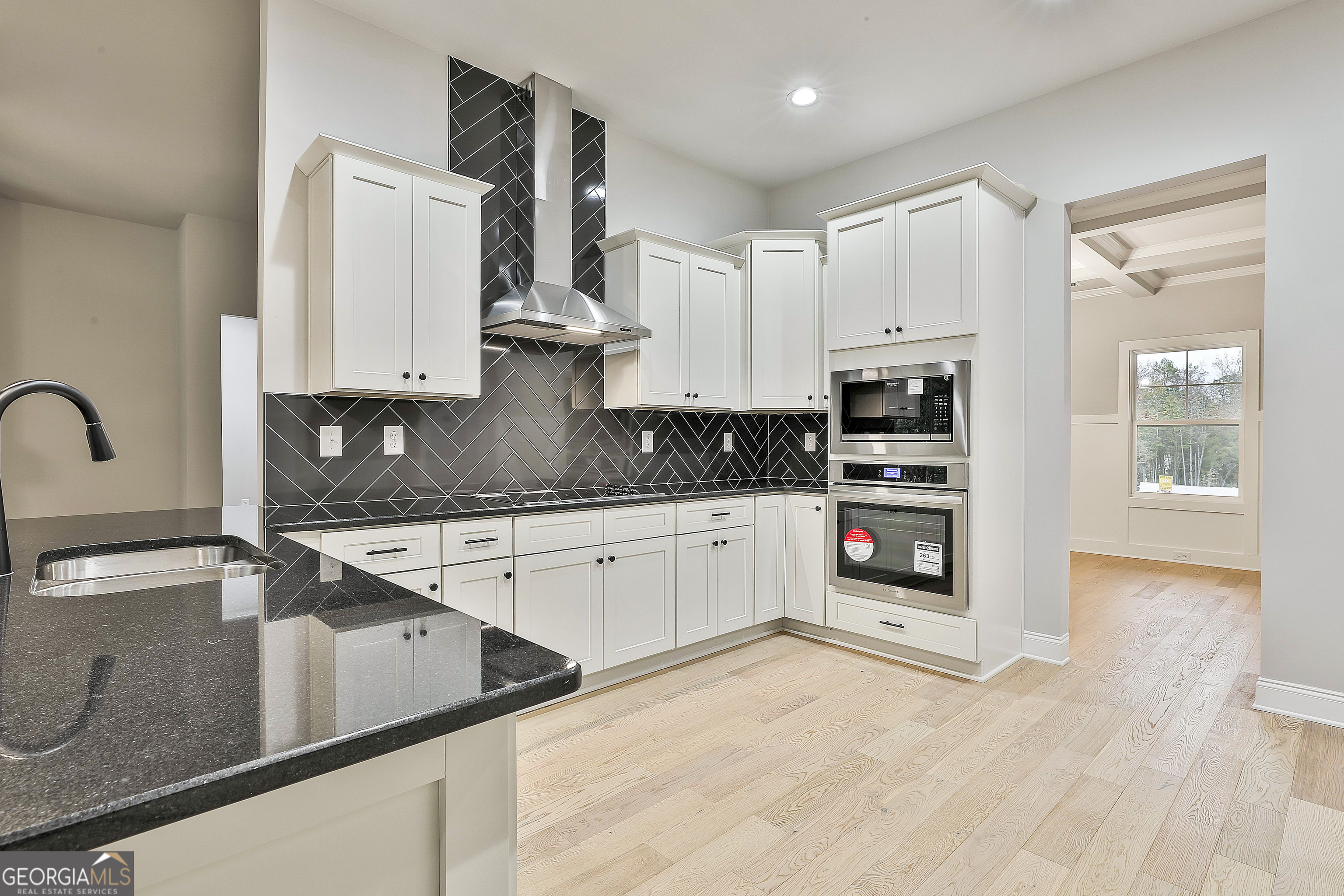 152 Wet Wood Drive, Unit 10 Fairburn, GA 30213 - Photo 21 of 39 a kitchen with stainless steel appliances granite countertop a sink stove and cabinets