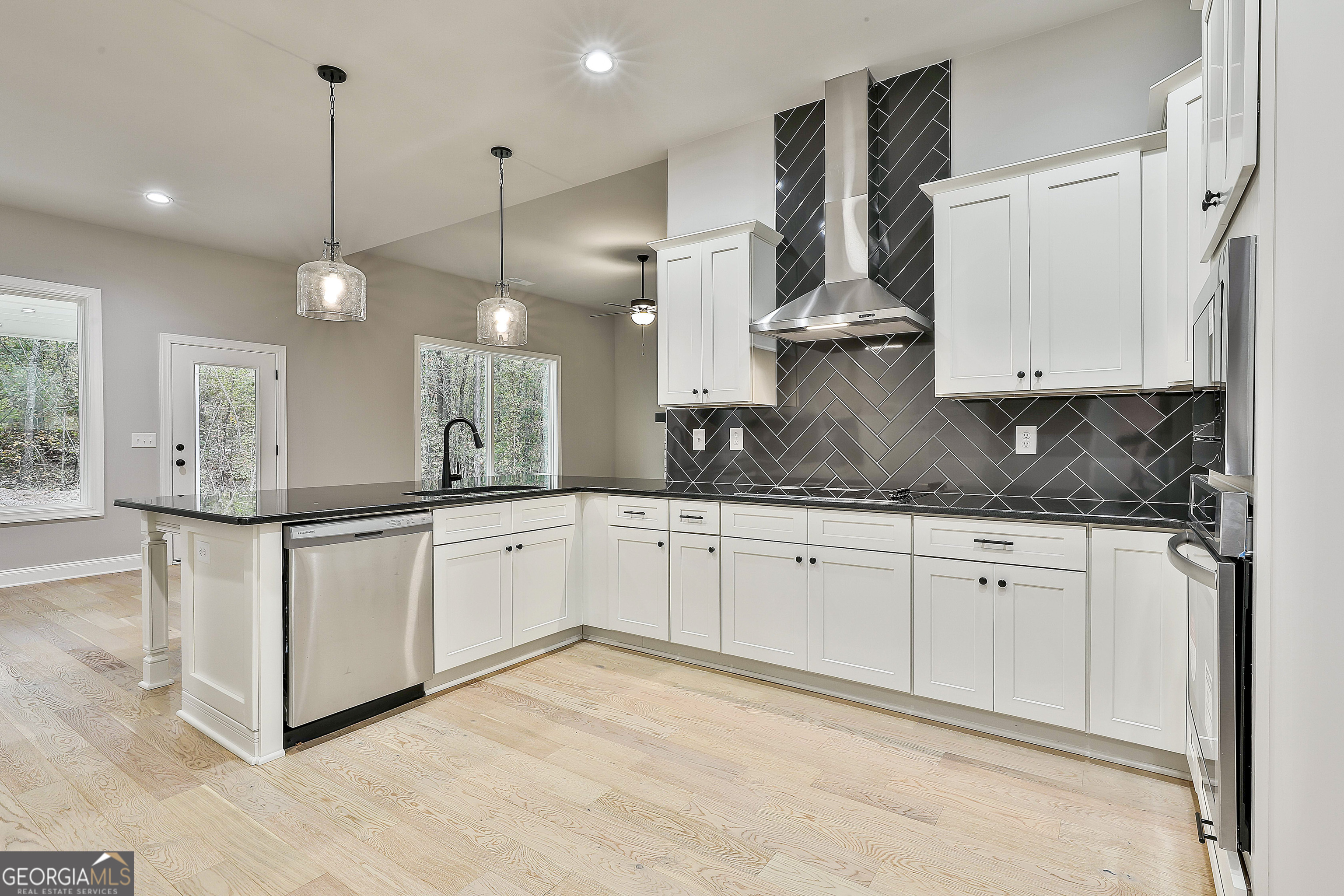 152 Wet Wood Drive, Unit 10 Fairburn, GA 30213 - Photo 22 of 39 a kitchen with stainless steel appliances granite countertop a sink a stove and white cabinets