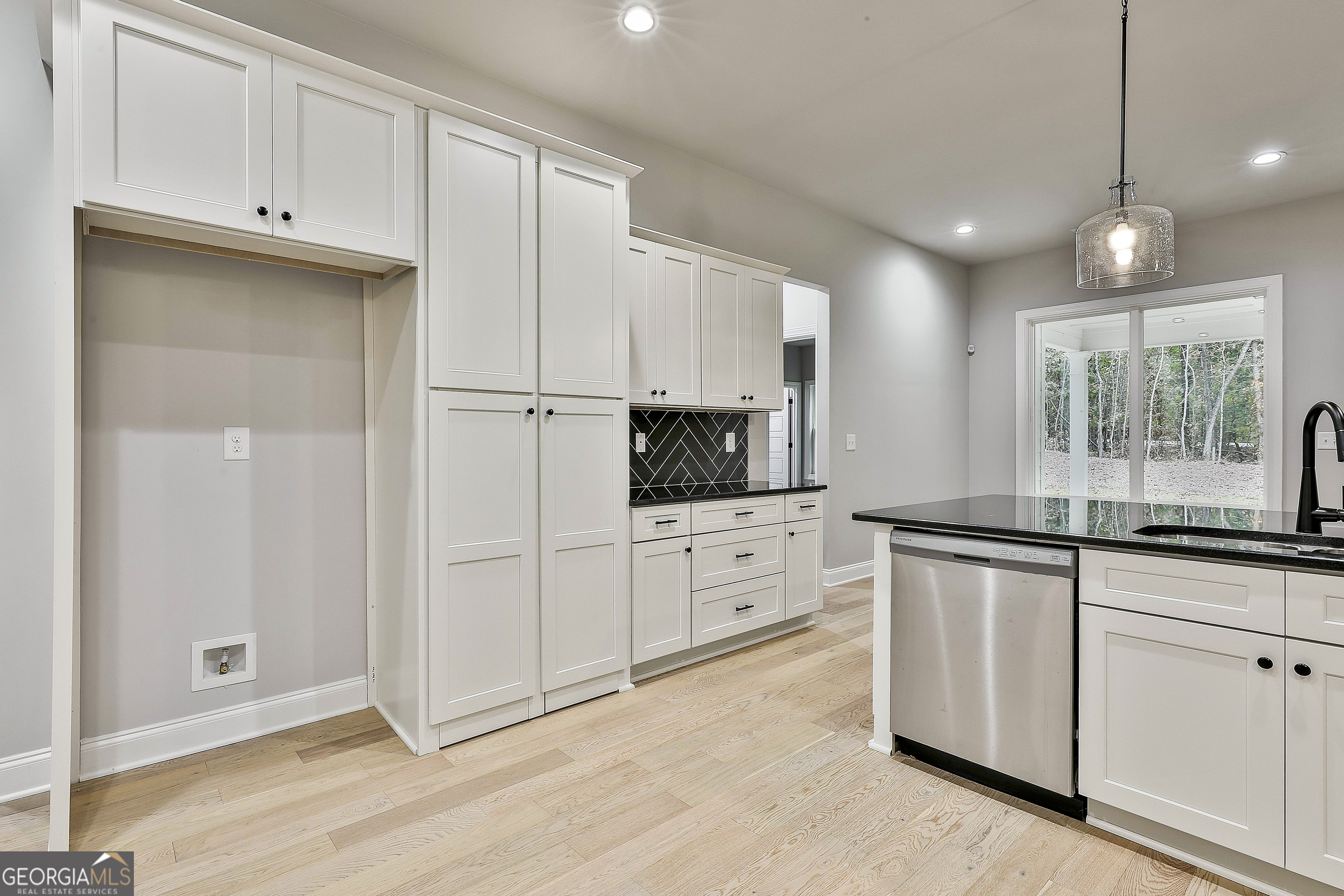 152 Wet Wood Drive, Unit 10 Fairburn, GA 30213 - Photo 23 of 39 a kitchen with granite countertop white cabinets and white appliances