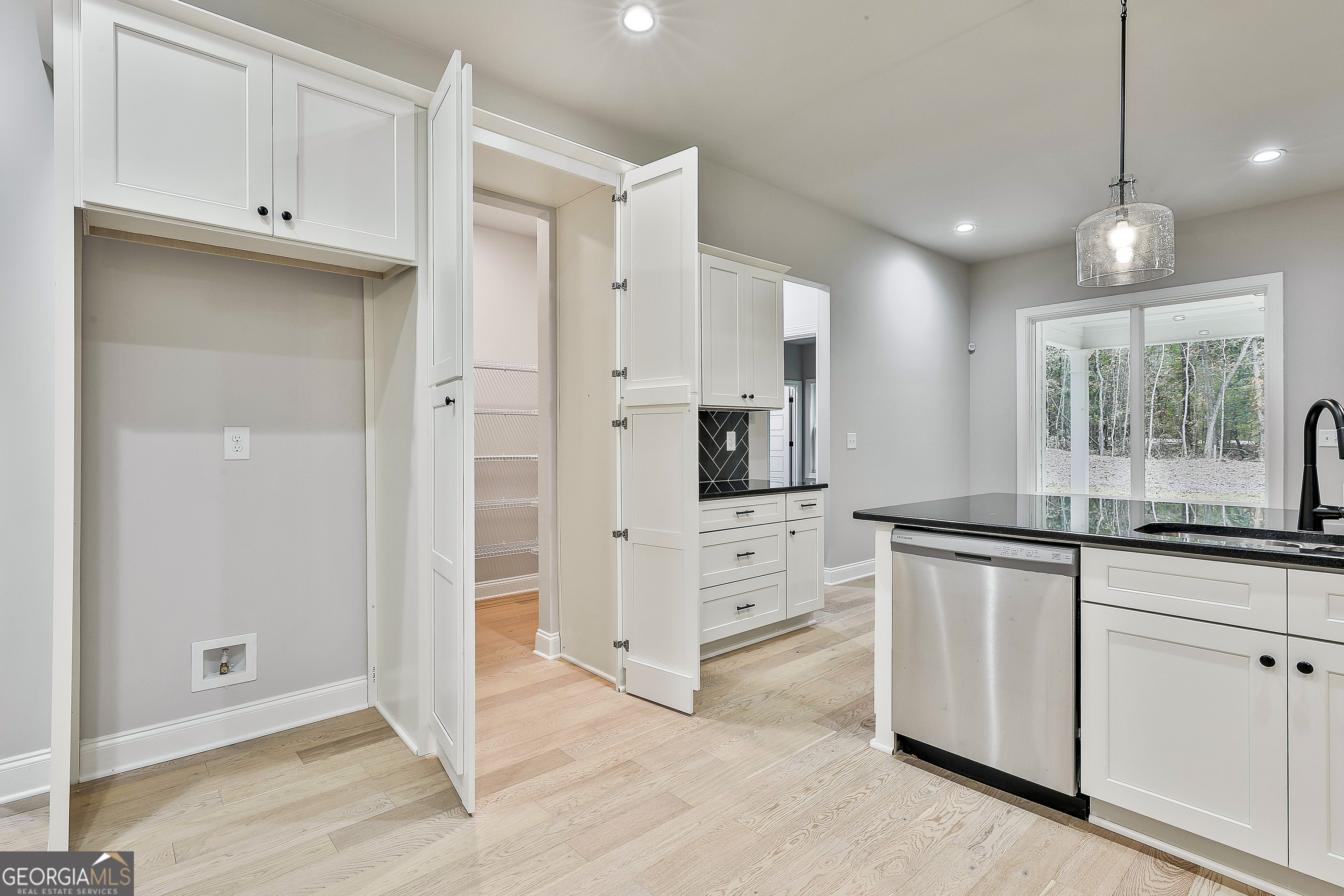 152 Wet Wood Drive, Unit 10 Fairburn, GA 30213 - Photo 24 of 39 a kitchen with granite countertop white cabinets and stainless steel appliances