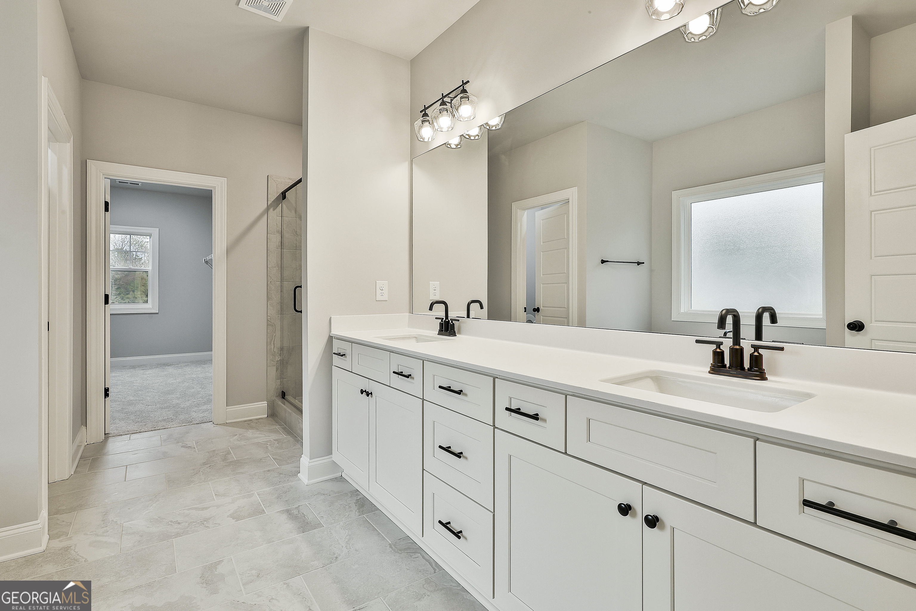 152 Wet Wood Drive, Unit 10 Fairburn, GA 30213 - Photo 29 of 39 a spacious bathroom with double sink and a mirror