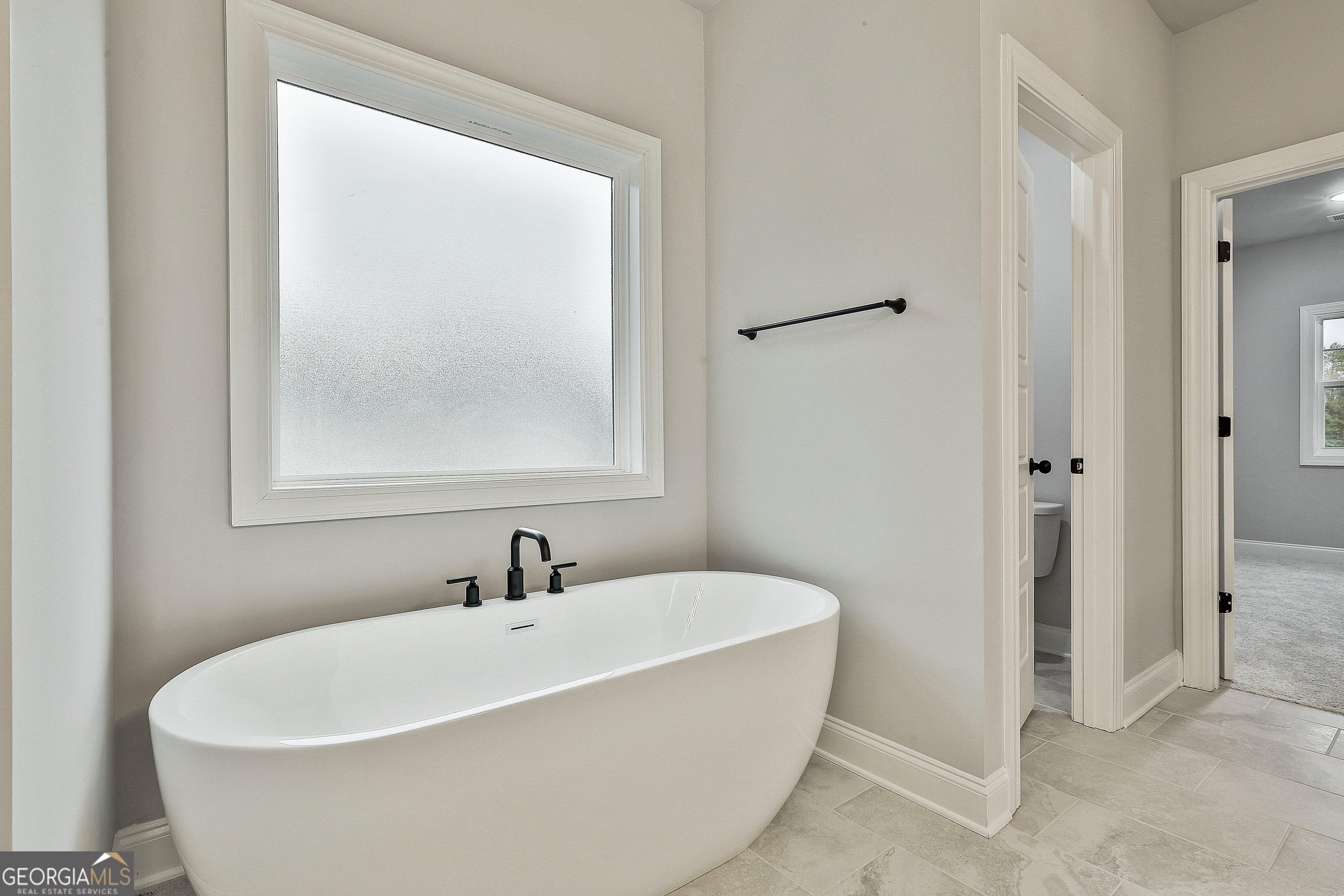 152 Wet Wood Drive, Unit 10 Fairburn, GA 30213 - Photo 30 of 39 a white bath tub sitting next to a white sink