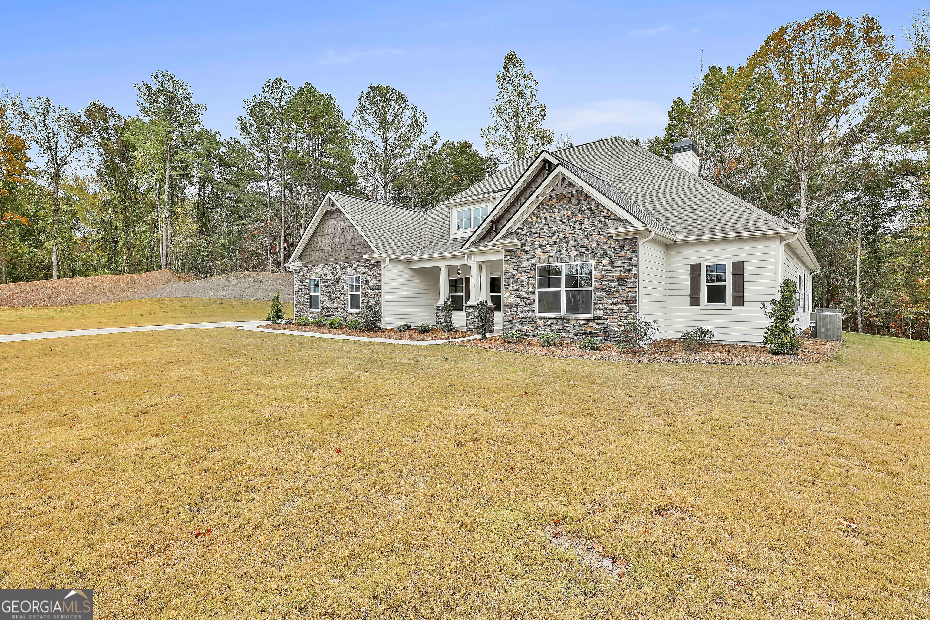 152 Wet Wood Drive, Unit 10 Fairburn, GA 30213 - Photo 3 of 39 a front view of a house with a yard