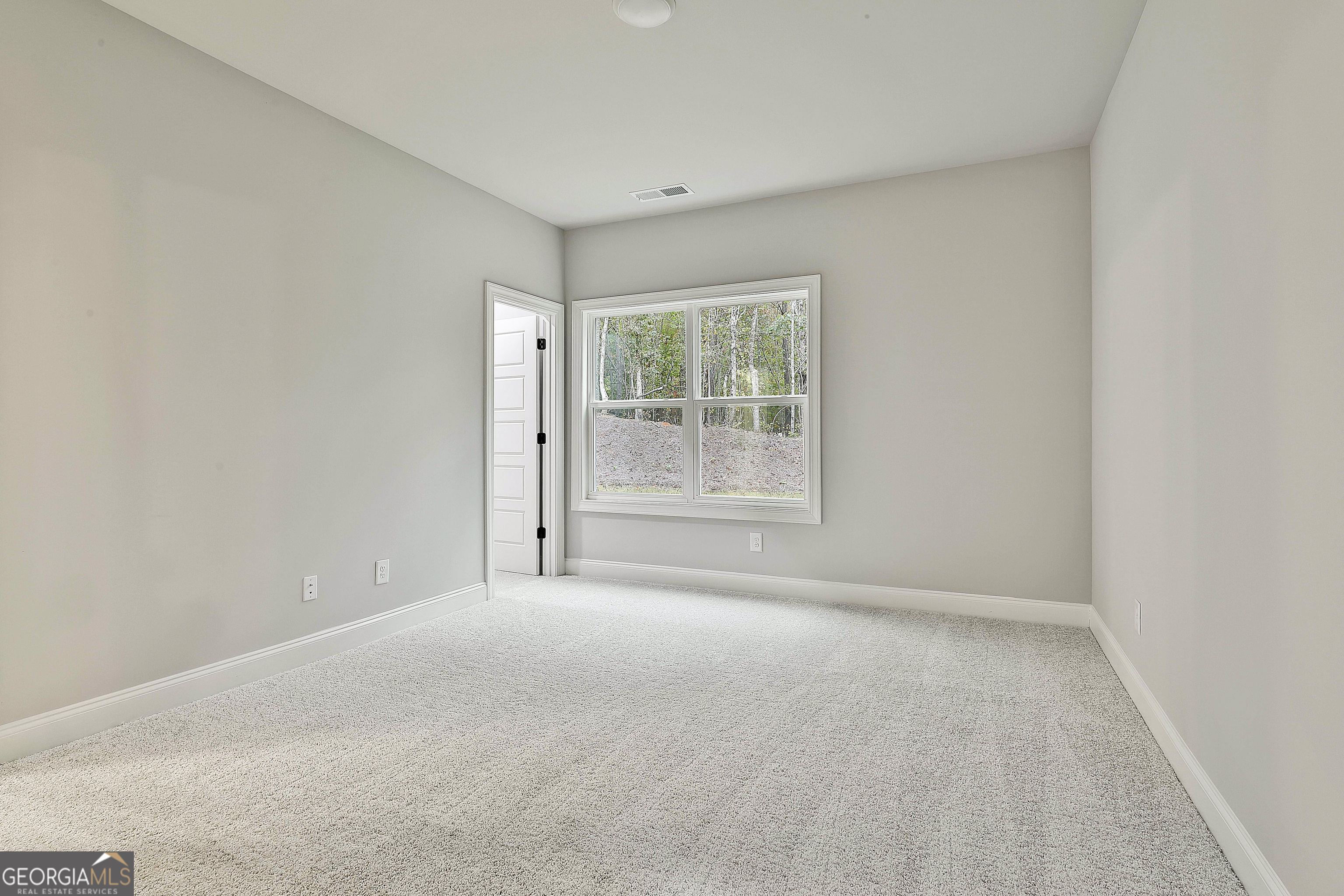 152 Wet Wood Drive, Unit 10 Fairburn, GA 30213 - Photo 32 of 39 a view of an empty room with a window