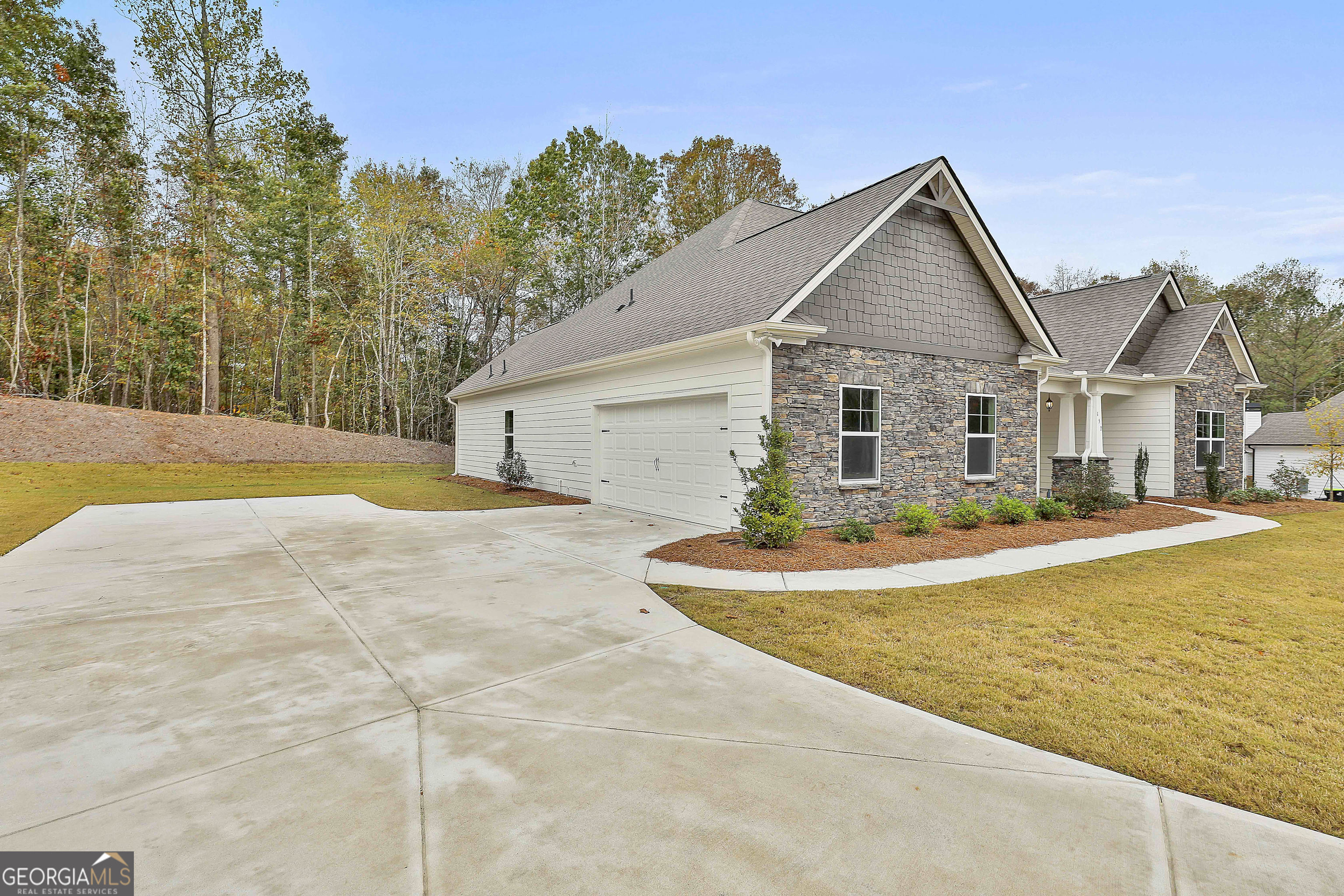 152 Wet Wood Drive, Unit 10 Fairburn, GA 30213 - Photo 4 of 39 a front view of house with yard and trees in the background