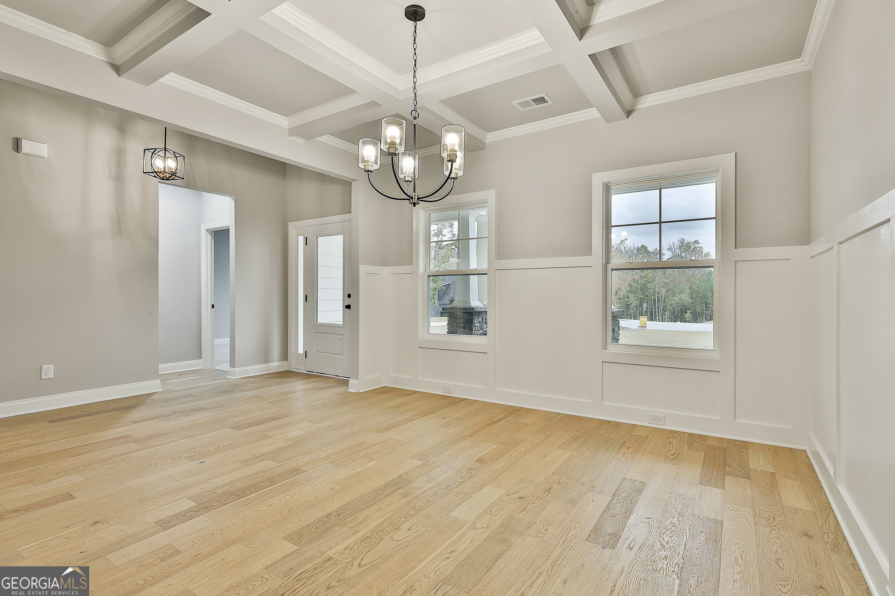 152 Wet Wood Drive, Unit 10 Fairburn, GA 30213 - Photo 10 of 39 an empty room with wooden floor and windows