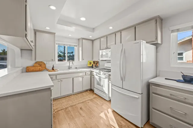 a kitchen with a sink stove and cabinets