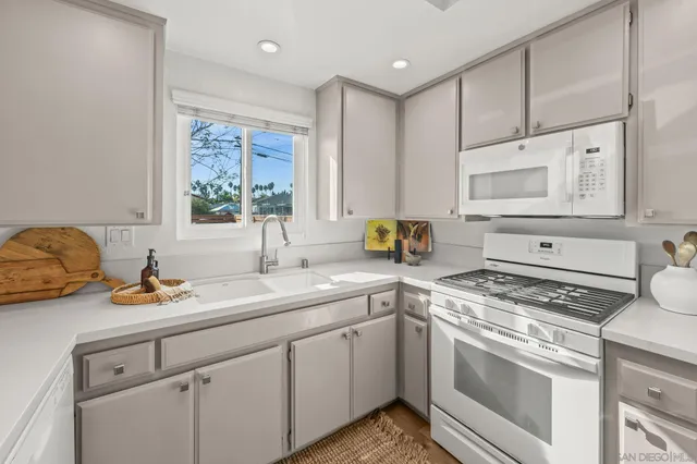 a bathroom with a granite countertop sink and a vanity