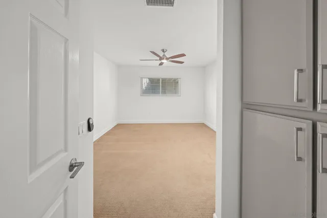 a view of walk in closet with empty racks