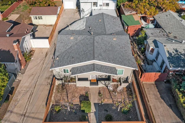 an aerial view of a house with a yard