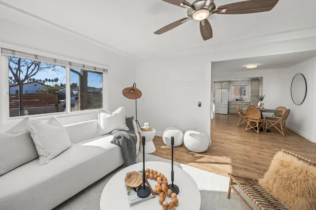 a dining room with furniture and a chandelier