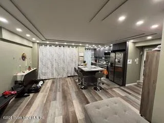 a living room with furniture a flat screen tv and a table