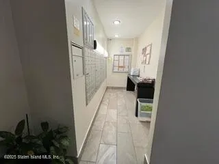a hallway with a sink and a mirror