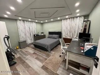 a bedroom with furniture and a wooden floor