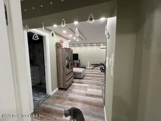 a view of a hallway with dining area and chandelier