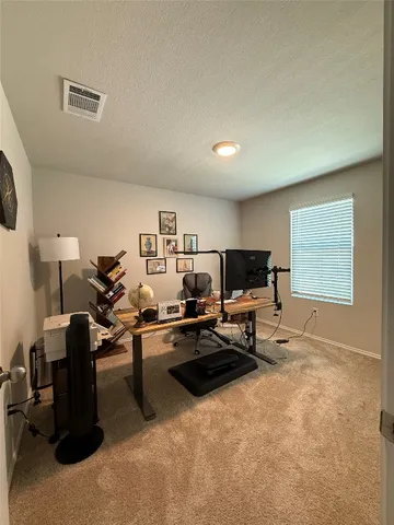 a living room with furniture a flat screen tv and a window