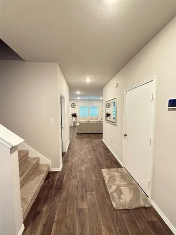 a view of hallway with wooden floor