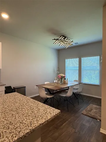 a view of a workspace with furniture and window