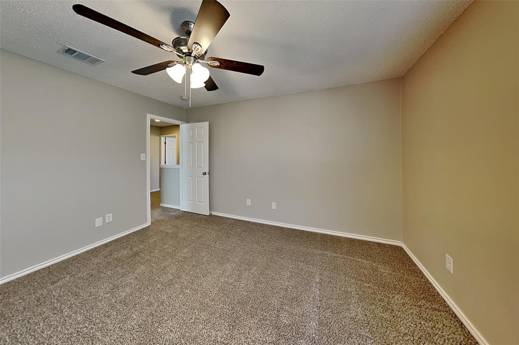 4224 Birch Creek Road Fort Worth, TX 76244 - Photo 14 of 19 an empty room with a chandelier fan and windows