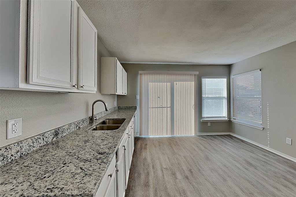 4224 Birch Creek Road Fort Worth, TX 76244 - Photo 4 of 19 a kitchen with granite countertop a stove and cabinets