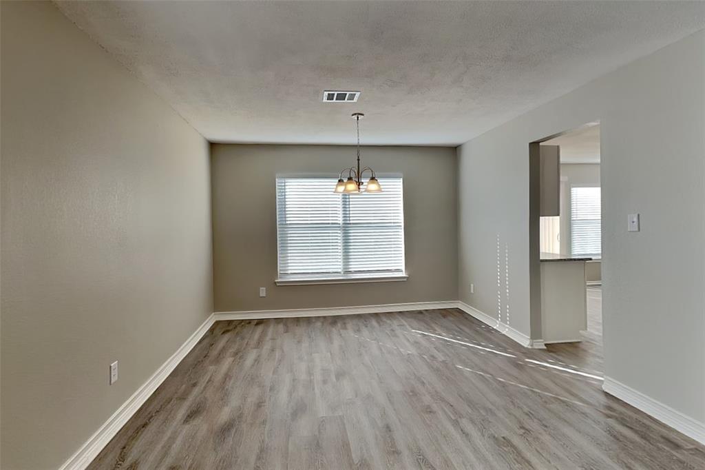 4224 Birch Creek Road Fort Worth, TX 76244 - Photo 6 of 19 an empty room with wooden floor and windows