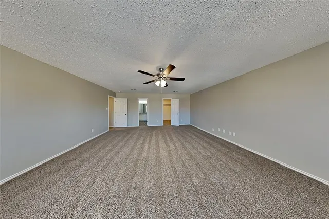 a view of a livingroom with a ceiling fan and hardwood floor