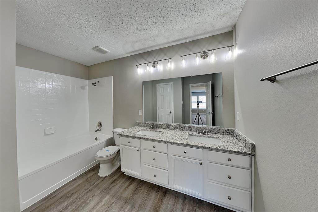 4224 Birch Creek Road Fort Worth, TX 76244 - Photo 10 of 19 a spacious bathroom with a granite countertop double vanity sink a mirror and a bathtub