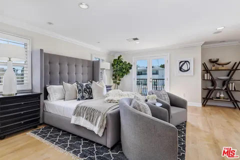 a bedroom with furniture and wooden floor