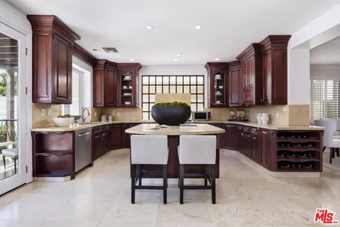 a kitchen with a refrigerator stove top oven and sink