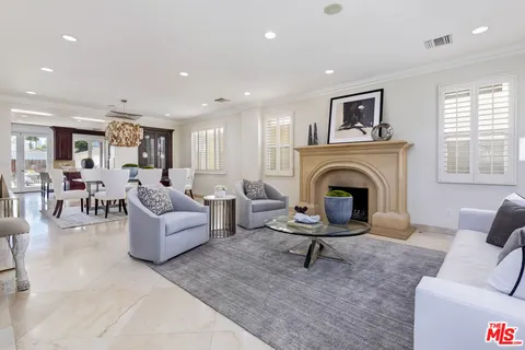 a living room with furniture a fireplace and a table