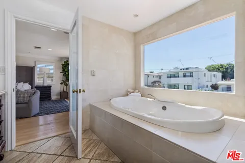 a spacious bathroom with a tub and sink