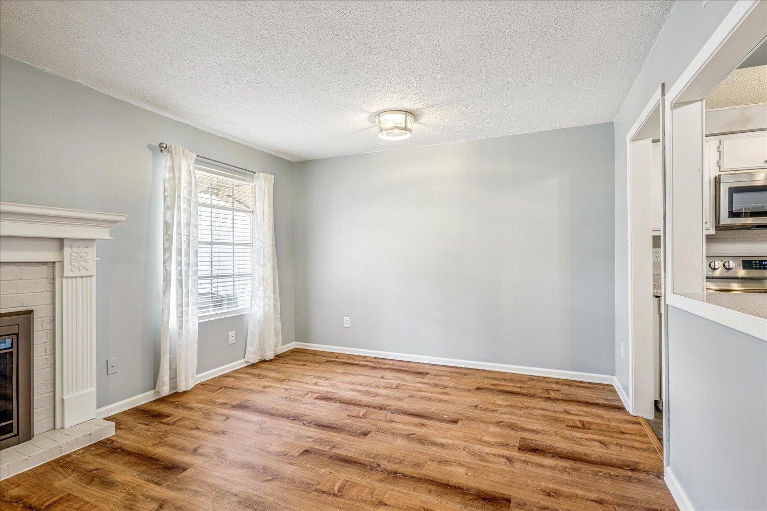 7503 Bavarian Drive, Unit 19 Germantown, TN 38138 - Photo 11 of 36 a view of empty room with wooden floor and fan