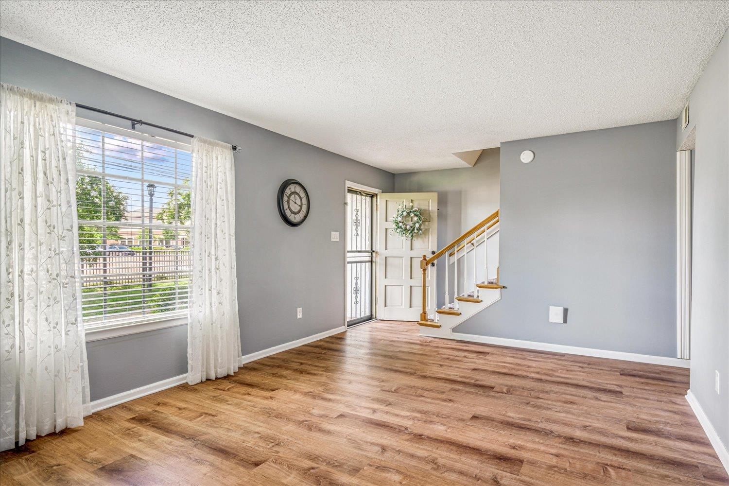 7503 Bavarian Drive, Unit 19 Germantown, TN 38138 - Photo 15 of 36 a view of an empty room with wooden floor and a window