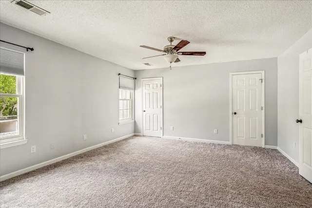 a view of room with a ceiling fan and hardwood floor