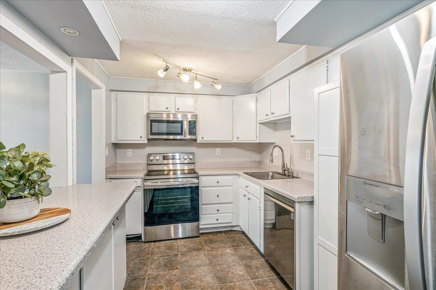 7503 Bavarian Drive, Unit 19 Germantown, TN 38138 - Photo 3 of 36 a kitchen with stainless steel appliances a stove a sink and a refrigerator