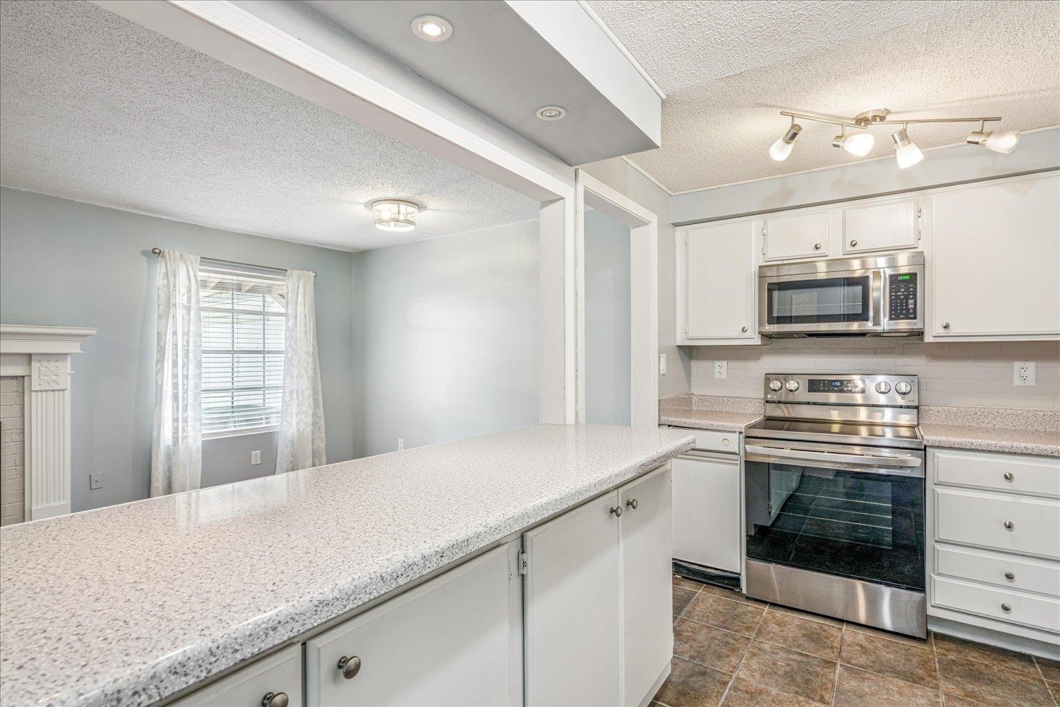 7503 Bavarian Drive, Unit 19 Germantown, TN 38138 - Photo 5 of 36 a kitchen with stainless steel appliances a stove microwave and sink