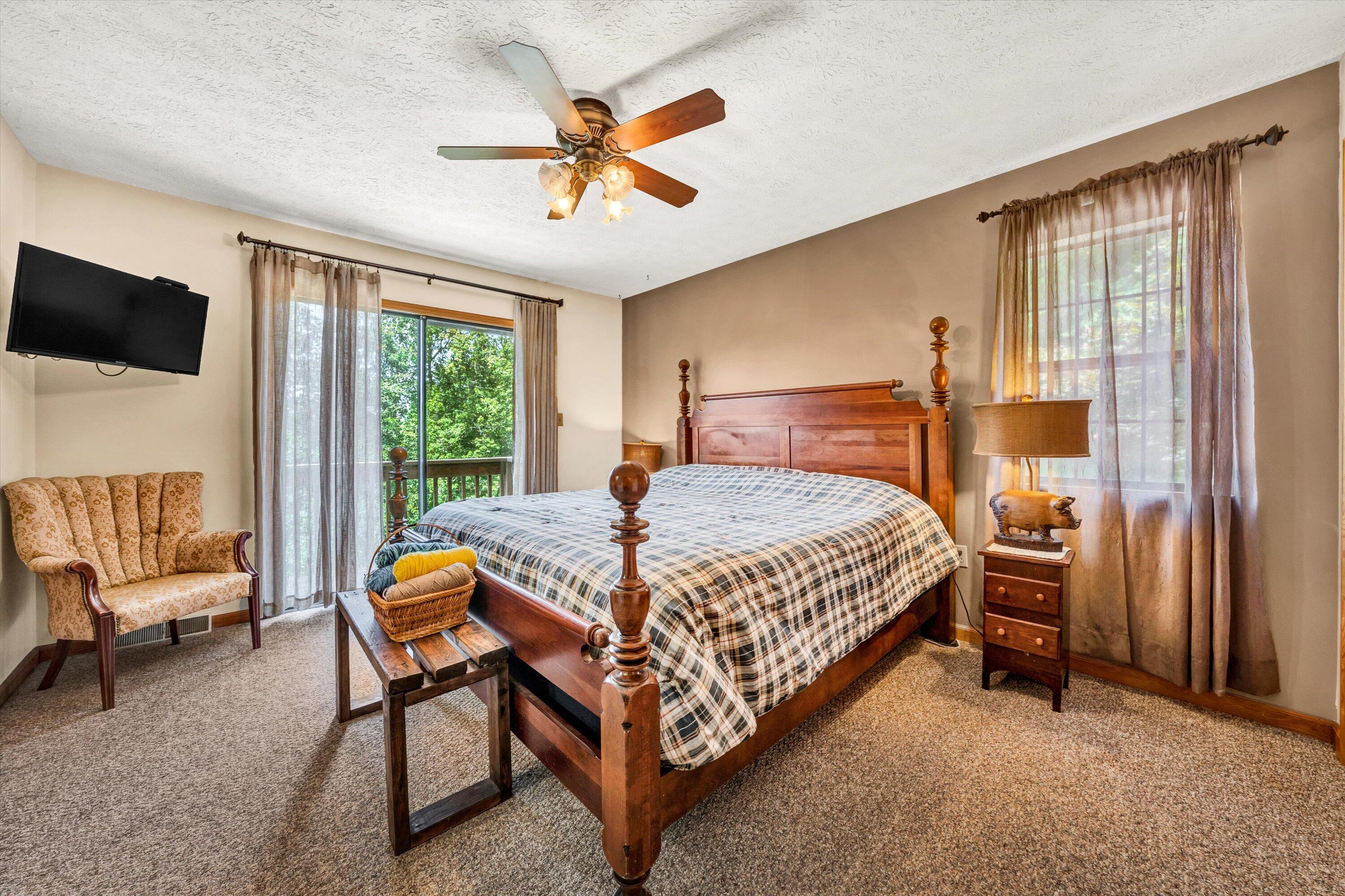 1595 Rock Spring Road Goodview, VA 24095 - Photo 25 of 50 a bedroom with a bed a couch and a chandelier