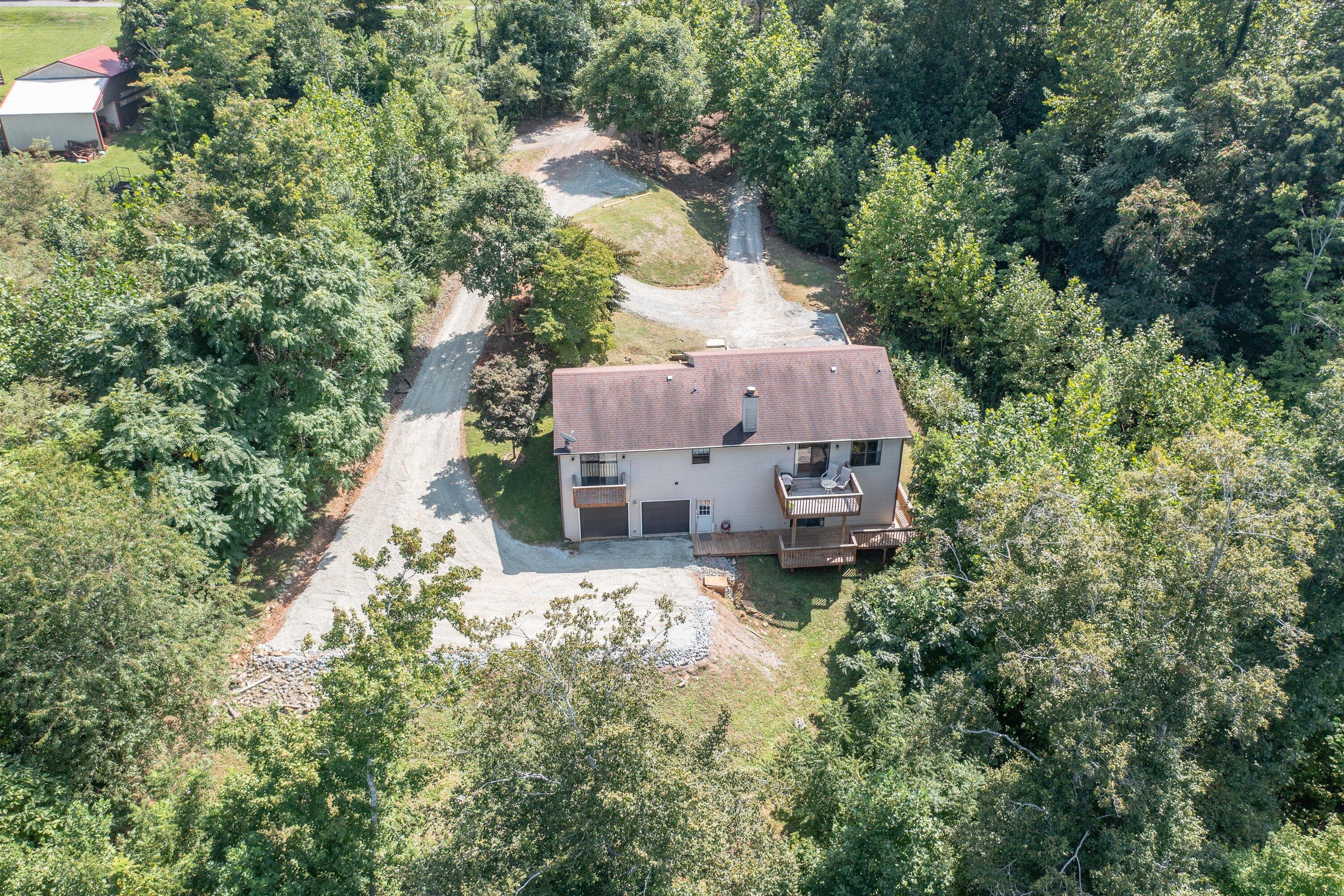 1595 Rock Spring Road Goodview, VA 24095 - Photo 41 of 50 an aerial view of a house with a yard and large trees