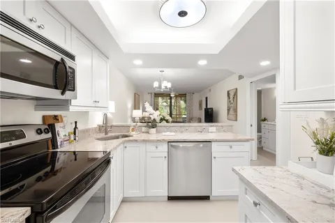 a kitchen with a sink stove and microwave