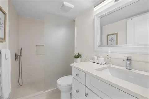 a bathroom with a sink toilet and shower