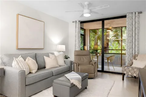 a living room with furniture and large windows