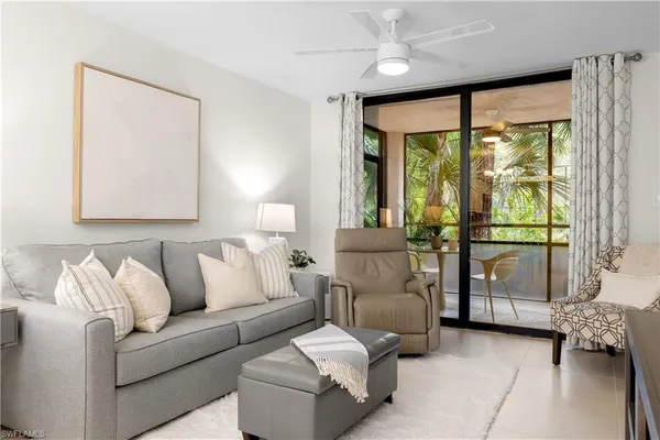 a living room with furniture and large windows