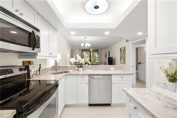 a kitchen with a sink stove and microwave
