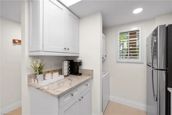 a kitchen with stainless steel appliances granite countertop a refrigerator and a sink