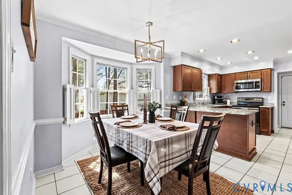 a kitchen with stainless steel appliances granite countertop a refrigerator stove and sink
