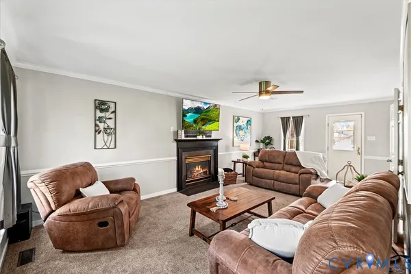 a living room with a fireplace and a flat screen tv